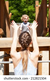 Boy Running To His Mum On The Playground