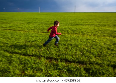 Boy Running On Green Field, Motion Blur