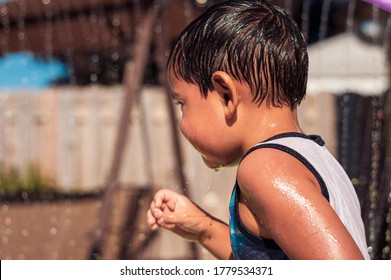 Boy Is Running At Pool Party, No Face. A Backyard Pool Party At Home With Kids