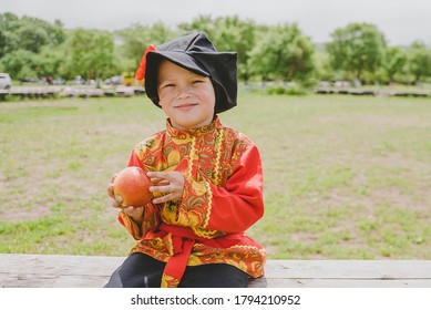 
Boy In Russian Folk Costume On The Background Of Nature