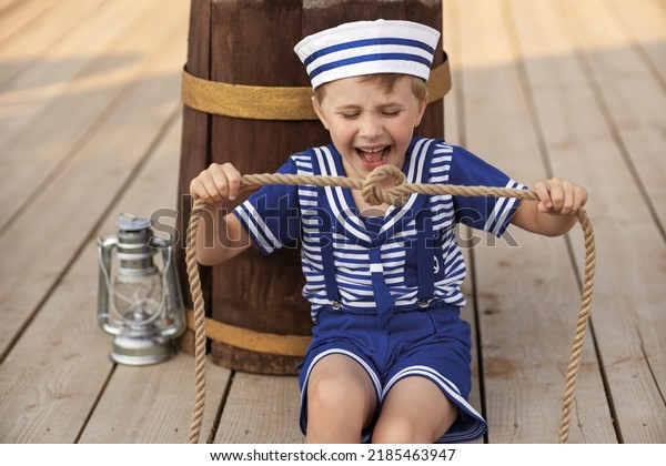
A boy in a sailor suit plays against the
backdrop of a wooden ship in the park. Portrait of a boy in a
sailor suit.
marine decor, marine
paraphernalia.