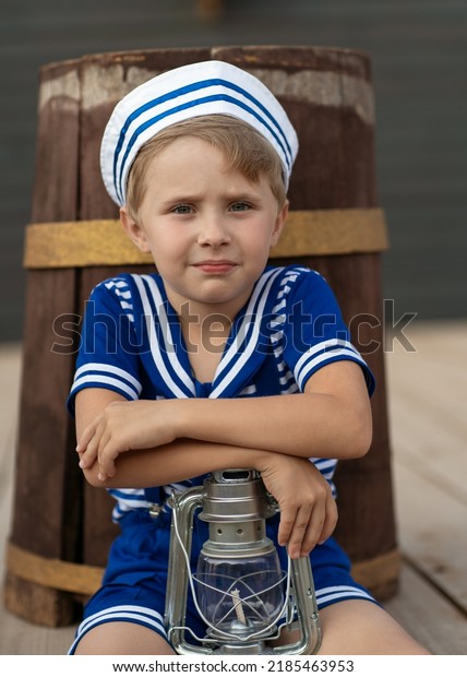 
A boy in a sailor suit plays against the
backdrop of a wooden ship in the park. Portrait of a boy in a
sailor suit.
marine decor, marine
paraphernalia.