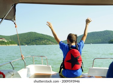 boy in savety jacket on cutter. water transportation on the lake.                             