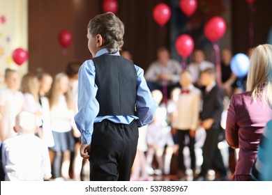 The Boy Of School Age In The Audience At The Festive Event At The School