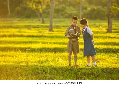 Boy Scout And Girl Scout Reading Book.