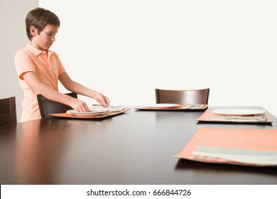 Boy Setting The Table