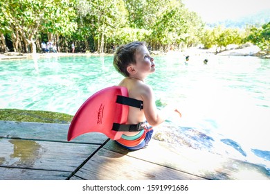 A Boy With A Shark Fin Is Waiting To Play In The Pool.The Emerald Pool. 22 October 2018 Krabi Thailand.