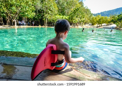 A Boy With A Shark Fin Is Waiting To Play In The Pool.The Emerald Pool. 22 October 2018 Krabi Thailand.