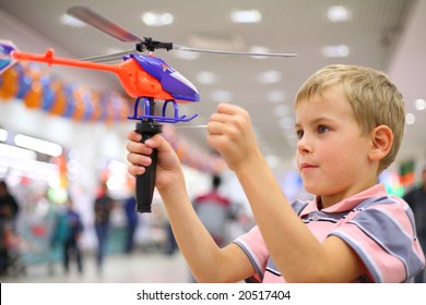 Boy In Shop With Toy Helicopter