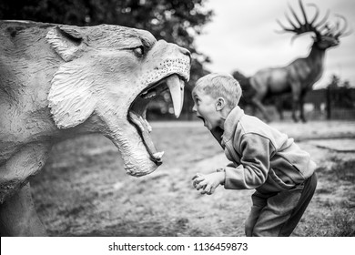 Boy shouting at the artificial saber-toothed tiger