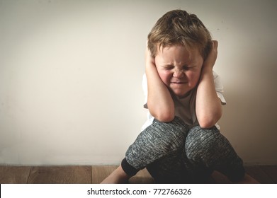 Boy Shouts Covered His Ears With His Hands. Stressed Child. Domestic Family Violence And Aggression Concept Violence. Concept For Bullying, Depression Stress Or Frustration.