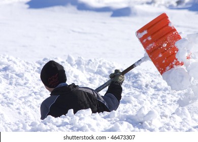 Boy Shoveling Deep Snow