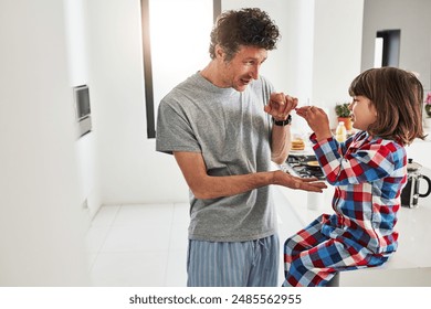 Boy, sign language and dad in kitchen of home, learning and ASL for deaf child. Hand gesture, teaching and morning with pyjamas and son with hearing disability, bonding and education with happy man - Powered by Shutterstock