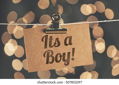 Its A Boy Sign Pegged To A String With Blurred Bokeh Lights In The Background