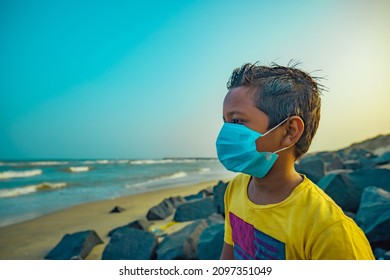 Boy Sitting Alone On The Beach With Medical Mask - Sad Indian Boy -Asian Boy 8-10 Years Old.