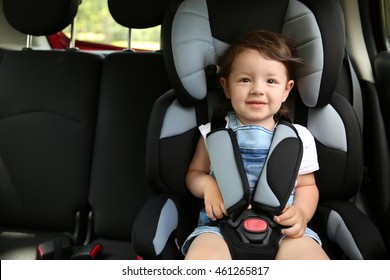 Boy Sitting In A Car In Safety Chair