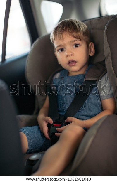 Boy sitting in a car in
safety chair