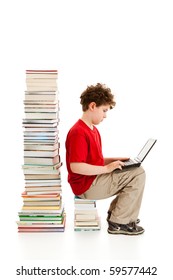 Boy Sitting Close To Pile Of Books Isolated On White Background