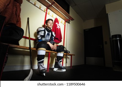 Boy Sitting On The Bench In Hockey Dressing Room