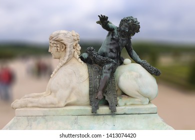 boy sitting on a female statute