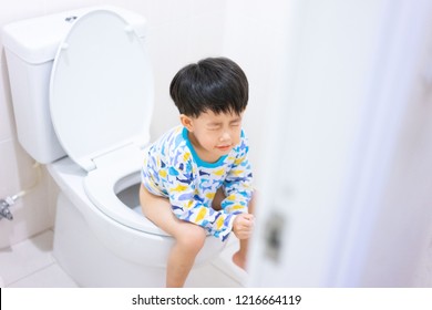 A Boy Is Sitting On Toilet With Suffering From Constipation Or Hemorrhoid.