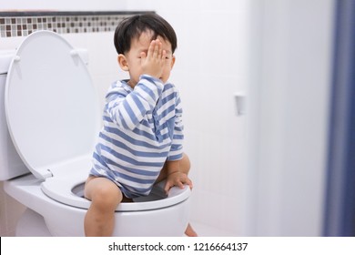 A Boy Is Sitting On Toilet With Suffering From Constipation Or Hemorrhoid.