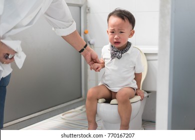 A Boy Is Sitting On Toilet With Suffering From Constipation Or Hemorrhoid.