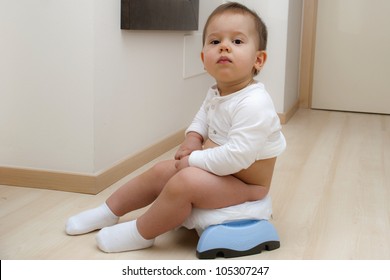 Boy sitting on a traveling potty