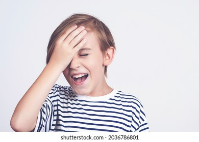 Boy Slapping Forehead With Palm And Closing Eyes. Unhappy Kid Forgetting Something. Face Emotion And Expression. Oops, What Did I Do. Back To School And News. Oh No. Boy Thinking About Mistakes.