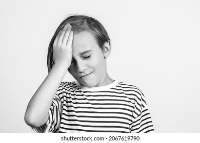 Boy Slapping Forehead With Palm And Closing Eyes. Unhappy Kid Forgetting Something. Face Emotion And Expression. Oops, What Did I Do. Back To School And News. Oh No. Boy Thinking About Mistakes.