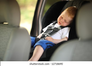 Boy Sleeping In Child Car Seat. Shallow DOF.