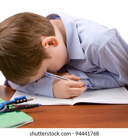 Boy sleeps at the table with books, isolated on a white background