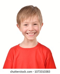 A boy is smiling on a white background. Isolated portrait of a child.