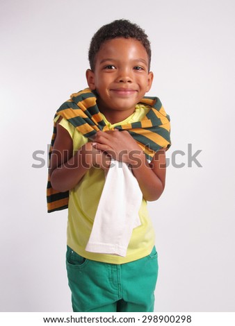A boy smiling over grey background. Vertical Shot.                                   