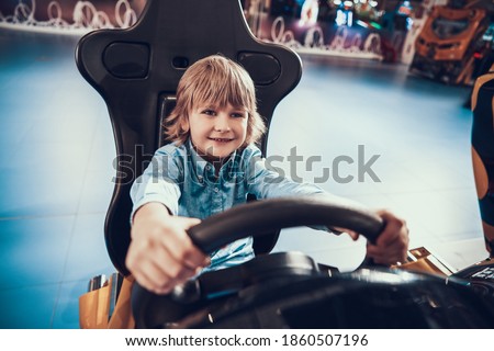 Boy Smiling While Playing With Toy Car on Floor