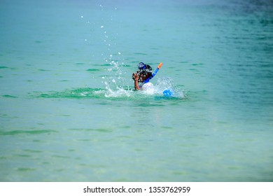 Boy  With Snorkle  In The Beautiful Sea Is Very Happy