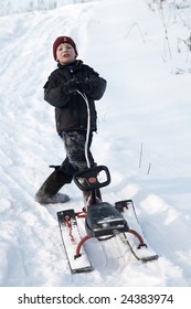 a boy, snow and sledge