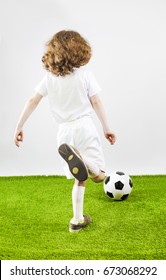 Boy With Soccer Ball On A Gray Background. Back View
