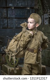 Boy Soldier Wearing A Cap With A Red Star Holding A Duffel Bag On His Shoulder