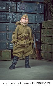 Boy Soldier Wearing A Cap With A Red Star Holding A Duffel Bag On His Shoulder