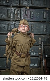 Boy Soldier Wearing A Cap With A Red Star Holding A Duffel Bag On His Shoulder