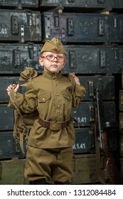 Boy Soldier Wearing A Cap With A Red Star Holding A Duffel Bag On His Shoulder