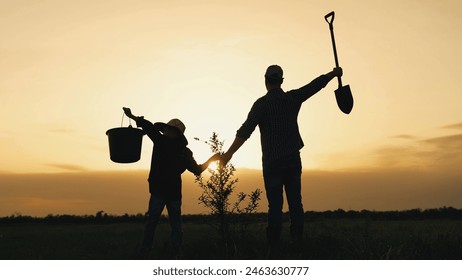 boy son child father tree shovel plant farmer gardener field garden silhouette sunset family parenting happy, son's first tree planting, tree growing family, son learning from father, teaching - Powered by Shutterstock