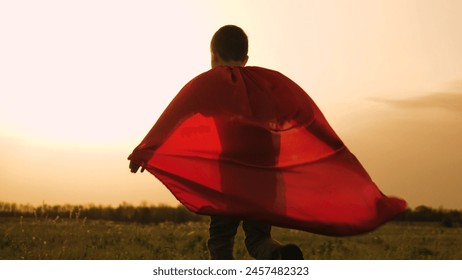 boy son child superhero game running park field sunset grass victory red cloak fancy dress, boy superhero costume, child red cape, kid sunset field, son playing hero, young masquerade outfit, little - Powered by Shutterstock