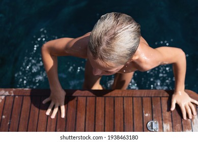 Boy spending summertime on yacht at mediterranean sea. Summer vacation for family at luxury yacht. Selective focus