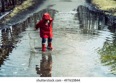 
Boy splashing in puddle