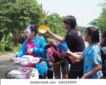 Boy are splashing water to friend on motercycle in Songkran festival in Thailand on April 13, 2018. Many boy and girl playing water at the street in their local.