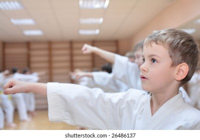 boy in sports hall is engaged in karate