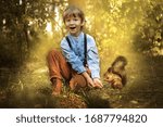 the boy and the squirrel are in the forest