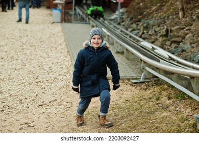 Boy Stand Near Electric Sleigh Ride On Rails. 